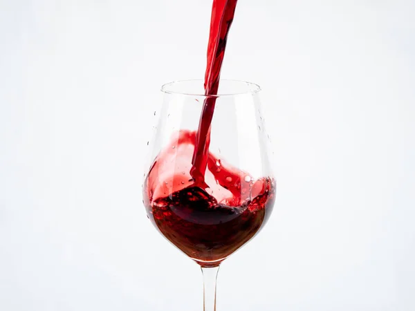 A glass of wine on a white background. Glass goblet with wine.