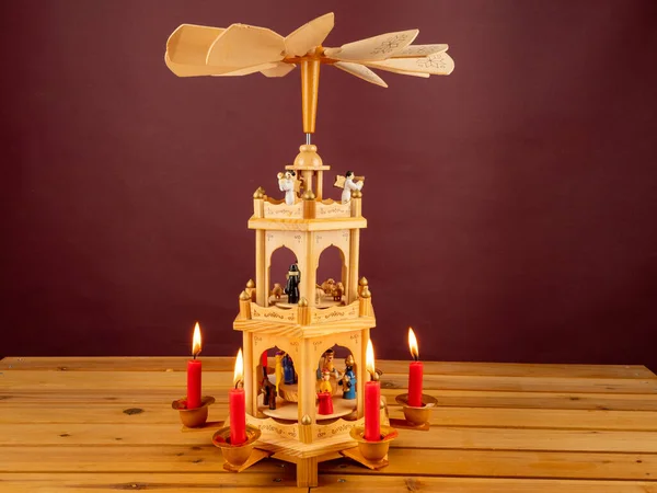 Christmas pyramid. Christmas carols, singers in the form of wooden figures. Christmas carousel.