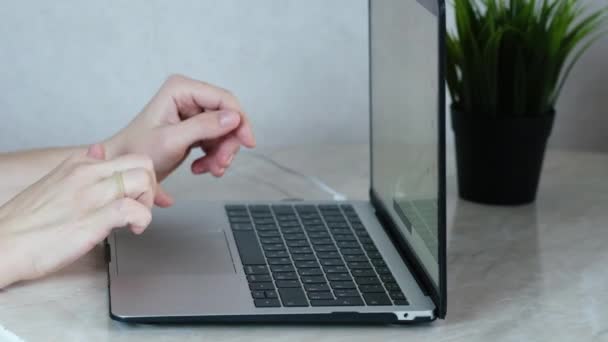 Le mani di una persona dalla pelle chiara digitare il testo su un computer portatile, il concetto di lavoro a distanza online — Video Stock