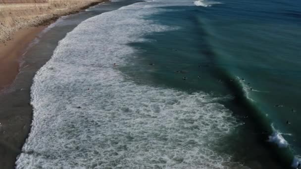 电影卢兹海滩航拍 阳光无人驾驶飞机与冲浪者一起飞越海岸线 美丽的房屋和蓝色的海水 — 图库视频影像