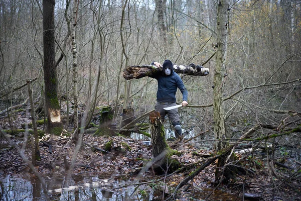 Serial killer Jason Voorhees in hockey mask and machete staying at the swamp. Friday 13th cosplay costume. — Stock Photo, Image