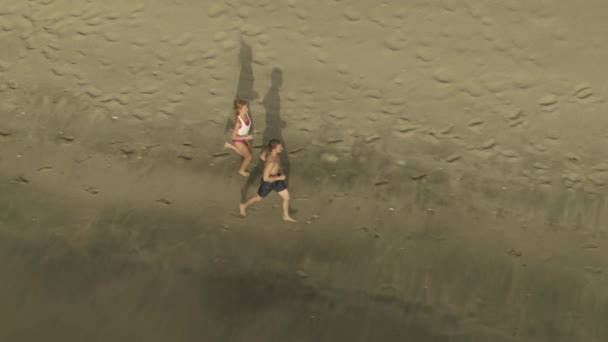 Aerial View Distant Couple Running Racing Ocean Beach Anse Roche — стокове відео