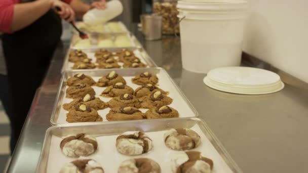 Medium Zoom Shot Baker Brushing Cookies Icing Salt Lake City Stockvideo