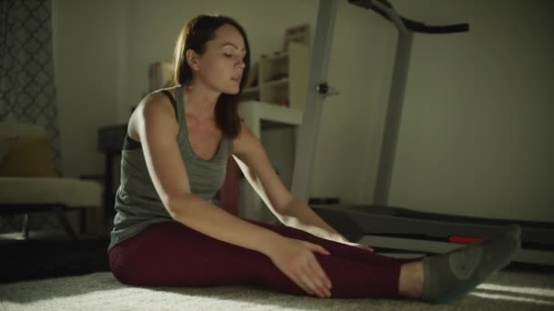 Woman Sitting Floor Night Holding Shins Stretching Legs Murray Utah — Vídeo de Stock