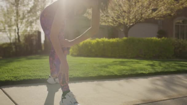 Medium Slow Motion Panning Shot Woman Stretching Legs Sidewalk Cedar — Stock Video