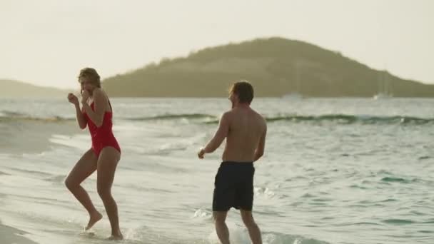 Playful Couple Splashing Each Other Ocean Beach Petit Tabac Tobago — стоковое видео