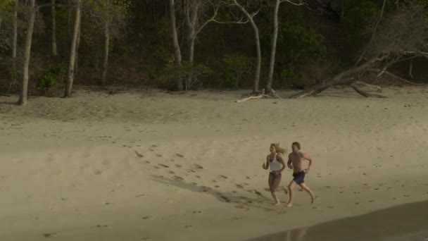 Aerial View Distant Couple Running Ocean Beach Anse Roche Bay — стокове відео