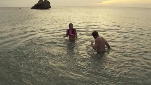 在格林纳达卡里亚库市Anse Roche湾 一对情侣在海里飞溅 然后接吻的慢镜头 — 图库视频影像