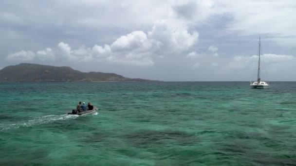 遠くのモーターボートが島 セントビンセント グレナディーン付近の海のカタマランに接近 — ストック動画