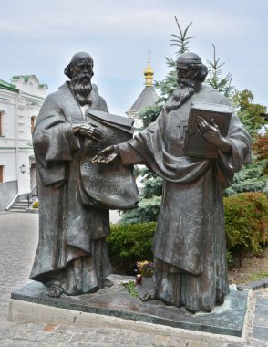 KYIV UKRAINE - 09 03 17: Saints cyril and methodius statue in Kiev Pechersk Lavra or Kyiv Pechersk Lavra also known as the Kiev Monastery of the Caves, is a historic Orthodox Christian monastery clipart
