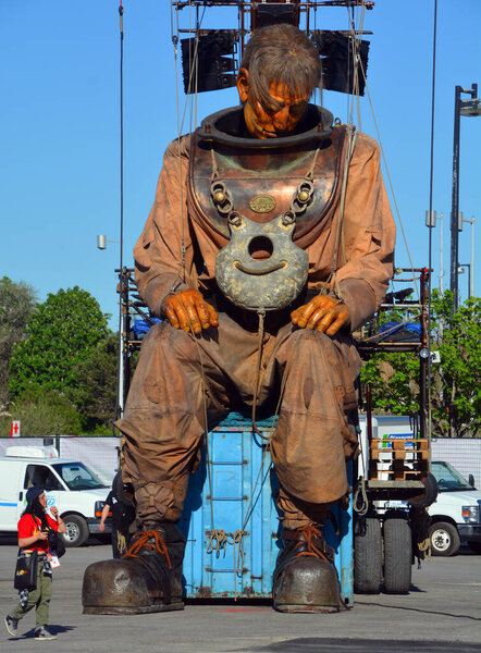MONTREAL QUEBEC CANADA - 19 05 17: The giant deep-sea diver walking in the street of Montreal for the 375e anniversary of the city, by Royal De Luxe company Nantes France