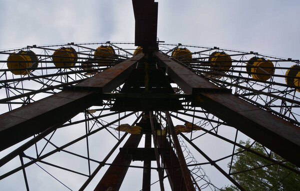 PRIPVAT CHERNOBYL UKRAINE - 09 03 17: Ferris wheel in Ghost City of Pripyat exclusion Zone of Chernobyl accident dominates the energy of most disastrous nuclear power plant accident in history