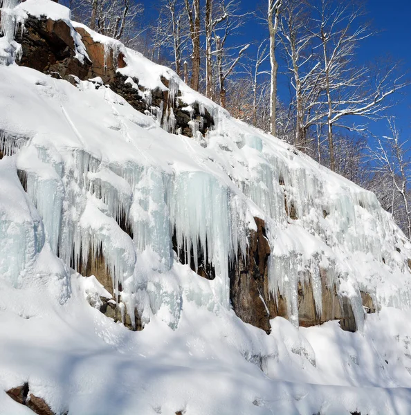 Winter landscape ice wall in Shefford mountain, ice runs off the rock, Eastern township Quebec, Canada