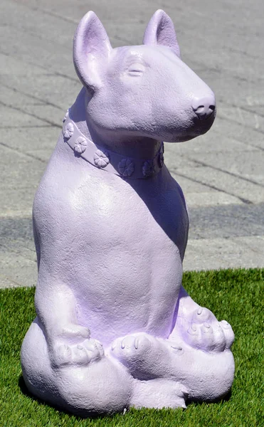 lilac sculpture of dog in the park