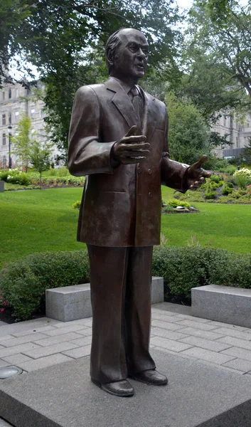 QUEBEC CITY QUEBEC CANADA 08 20 2020: Statue of Rene Levesque former prime minister in front the National Assembly of Quebec is the legislative body of the province of Quebec