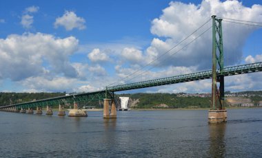 QUEBEC CANADA 08 24 2020: Ile d'orlean bridge and Montmorency Falls is a large waterfall on the Montmorency The falls are located on the boundary between the borough of Beauport, and Boischatel