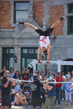 QUEBEC CITY QUEBEC CANADA 08 23 2020: Young acrobat entertain people in the heart of Quebec city downtown street