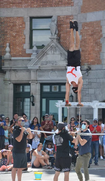 QUEBEC CITY QUEBEC CANADA 08 23 2020: Young acrobat entertain people in the heart of Quebec city downtown street
