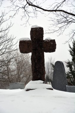 MONTREAL CANADA 02 16 2021: Christmas time. Monument in Notre-Dame-des-Neiges Cemetery during a sunny day after snow storm. Is the largest cemetery in Canada and the third-largest in North America