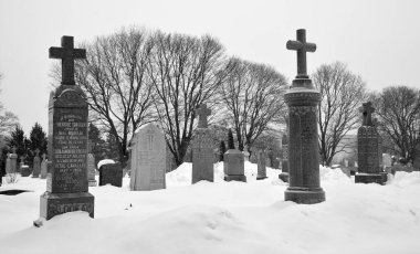 MONTREAL CANADA 02 16 2021: Christmas time. Monument in Notre-Dame-des-Neiges Cemetery during a sunny day after snow storm. Is the largest cemetery in Canada and the third-largest in North America