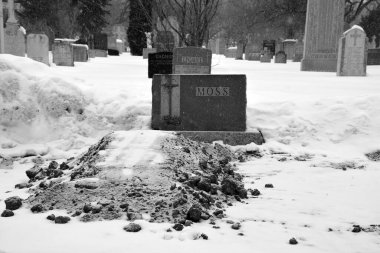 MONTREAL CANADA 02 16 2021: Christmas time. Monument in Notre-Dame-des-Neiges Cemetery during a sunny day after snow storm. Is the largest cemetery in Canada and the third-largest in North America