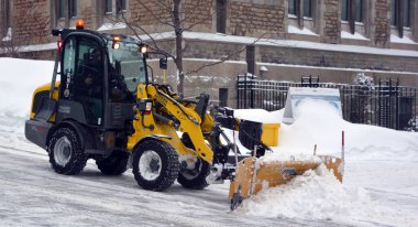 MONTREAL QUEBEC CANADA 02 17 2021: Sidewalk snowplow is a device intended for mounting on a vehicle, used for removing snow and ice from outdoor surfaces