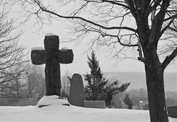 MONTREAL CANADA 02 16 2021: Christmas time. Monument in Notre-Dame-des-Neiges Cemetery during a sunny day after snow storm. Is the largest cemetery in Canada and the third-largest in North America