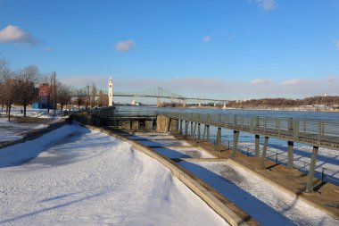 view of the river and the bridge in the city at winter