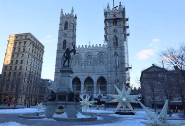 MONTREAL CANADA 02 15 2022: Place d'arme and Notre-Dame Basilica (French: Basilique Notre-Dame de Montreal) is a basilica in the historic district of Old Montreal