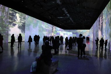 crowd of people at the exhibition indoors