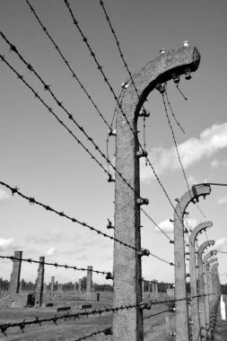 AUSCHWITZ BIRKENAU POLAND 09 17 17: Auschwitz concentration camp fences was a network of German Nazi concentration camps and extermination camps built and operated by the Third Reich in Poland in black and white