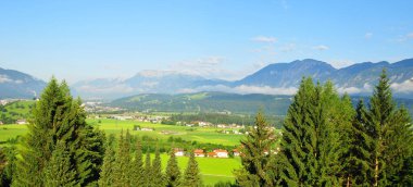 beautiful landscape with village in the mountains and green trees