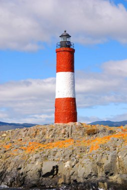 lighthouse on shore in front of mountains, Canada