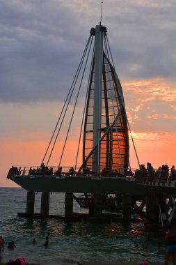 sunset over the sea. People at pier