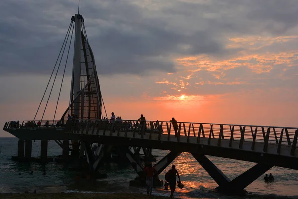 sunset over the sea. People at pier