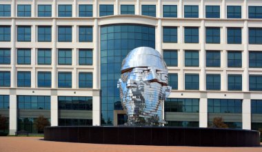 METALmorphosis is a large (7 metre, 13 tonne) kinetic sculpture of a human head, by Czech artist David Cerny
