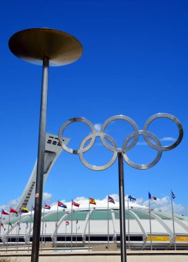 MONTREAL CANADA AUGUST 17 2015 : Montreal Olympic Stadium tower & olympic rings & cauldron. It's the tallest inclined tower in the world.Tour Olympique stands 175 meters tall and at a 45-degree angle