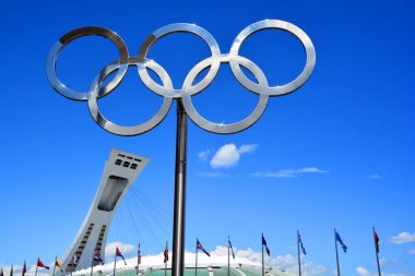 MONTREAL CANADA AUGUST 17 2015 : Montreal Olympic Stadium tower & olympic rings & cauldron. It's the tallest inclined tower in the world.Tour Olympique stands 175 meters tall and at a 45-degree angle