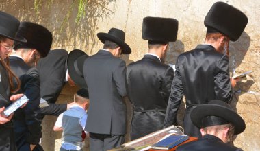JERUSALEM ISRAEL 26 10 16: Jewish hasidic men pray a the Western Wall, Wailing Wall the Place of Weeping is an ancient limestone wall in the Old City of Jerusalem. Second Jewish Temple by Herod the Great
