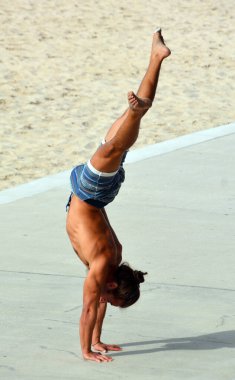 TEL AVIV ISRAEL NOV 04 2016: Young man made exercise on the beach. Israel is dedicated to keeping its citizens healthy. Workout parks are mini gyms with machines that use body weight as resistance.