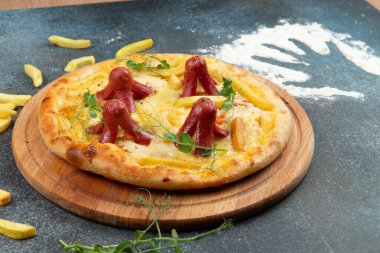 Homemade pizza with sausages. On a gray background. Selective focus.