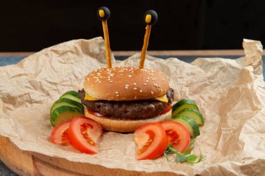 The burger is decorated in the shape of a crab. Crab Burger. Crabsburger. Selective focus.
