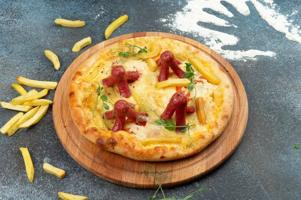 Homemade pizza with sausages. On a gray background. Selective focus.