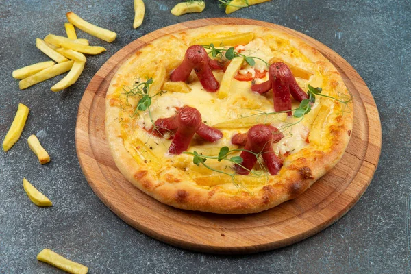 Homemade pizza with sausages. On a gray background. Selective focus.