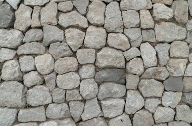 Düzgünce kaba kesme taş duvar sorunsuz doku arka plan yığılmış.