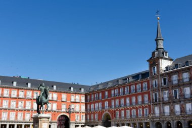 Plaza Mayor in Madrid and the statue of Philip III, with a clear blue sky. Main Square.