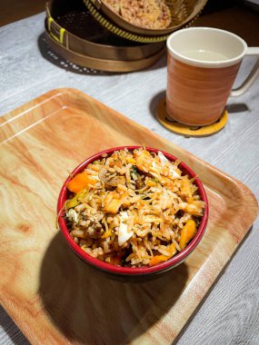 Bir kase baharatlı pilav, sebzeli, sahanda yumurta, erişte. Huysuz ve beyaz arka planda servis edilmiş. Seçici odak