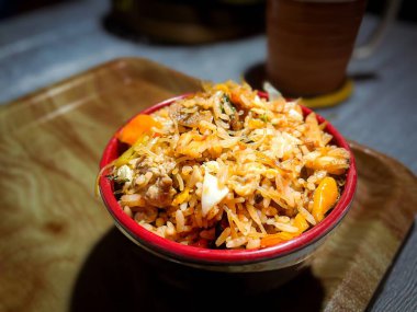 Bir kase baharatlı pilav, sebzeli, sahanda yumurta, erişte. Huysuz ve beyaz arka planda servis edilmiş. Seçici odak