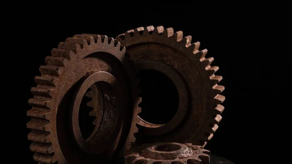 Old rusty metal gears on a black background close-up Royalty Free Stock Images