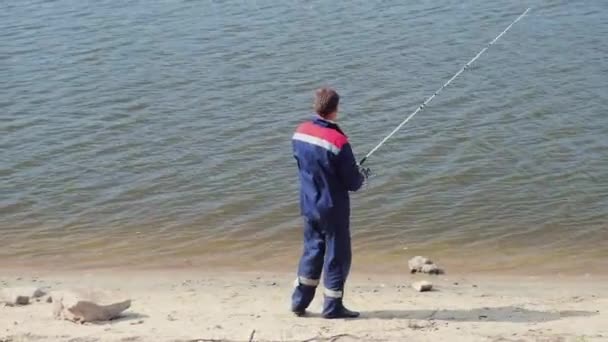 Pêcheur sur la ligne de pêche côtière sur la filature — Video